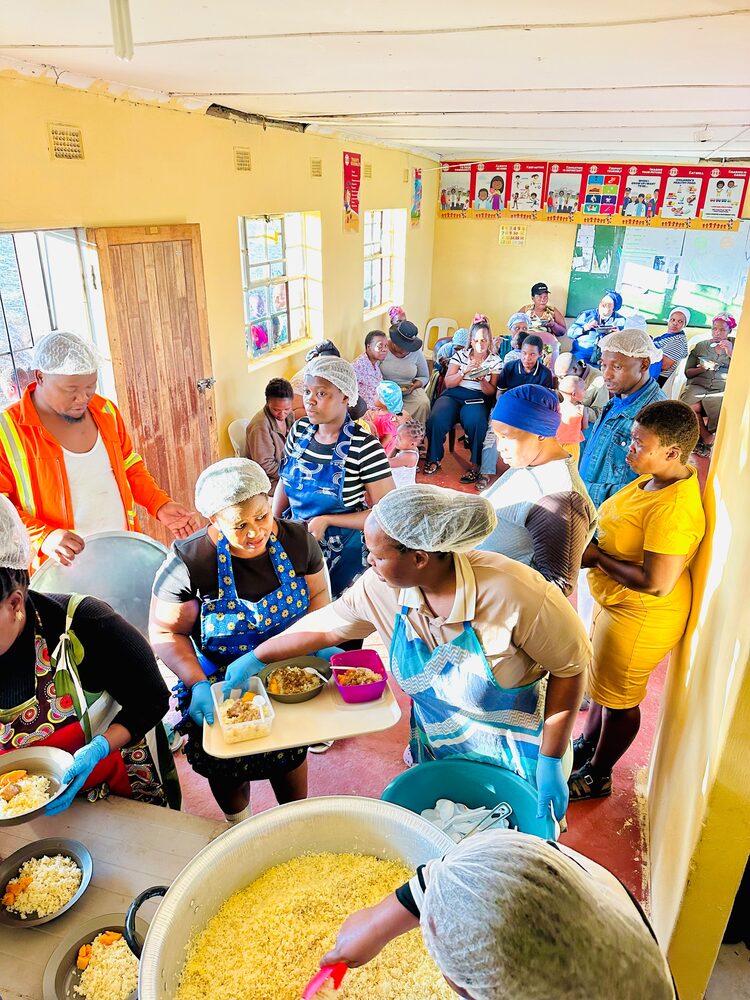 Volunteers serving food at a UGM feeding programme